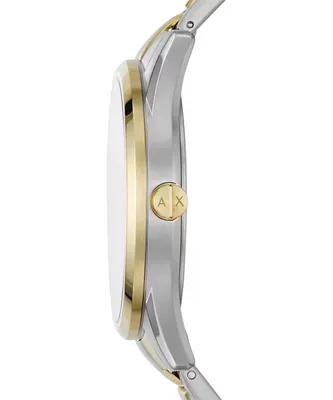 Side view of a silver and gold watch with a gold button featuring the 'AX' logo.