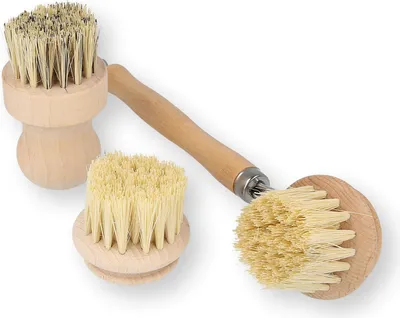 Three wooden brushes with natural bristles are arranged on a white background.