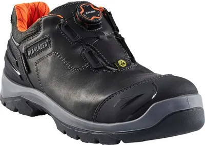 A black safety shoe with orange accents.