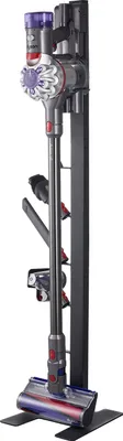 A Dyson vacuum cleaner and its accessories are mounted on a black stand.