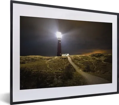 Produktbild von MuchoWow® MuchoWow® Gerahmtes Poster Ein beleuchteter Leuchtturm auf der Insel Schiermonnikoog 40x30 cm - Poster mit zchwarzem Bilderrahmen - Bilderrahmen - Poster im Rahmen