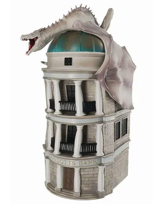 A detailed model of Gringotts Bank with a dragon on top, presented against a white background.