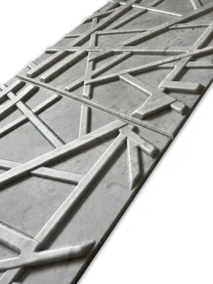 A close-up, angled view of a decorative wall panel with a geometric pattern.