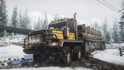 A heavy-duty truck carrying pipes through a snowy, muddy terrain.