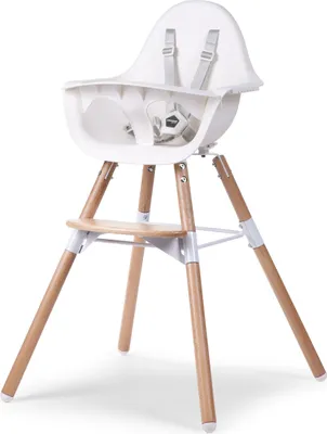 A white high chair with wooden legs is shown against a white background.