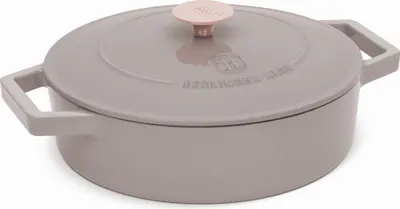 A gray cast iron pot with a pink knob on the lid.