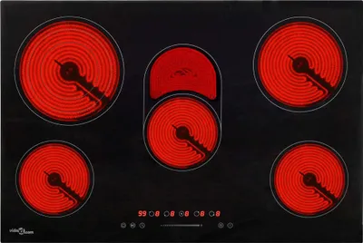 A top-down view of a black glass-ceramic cooktop with five heating elements that are glowing red.