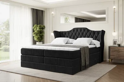 A bedroom scene with a large bed as the focal point.