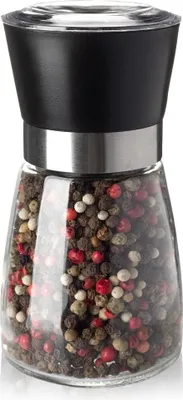A pepper mill filled with peppercorns.