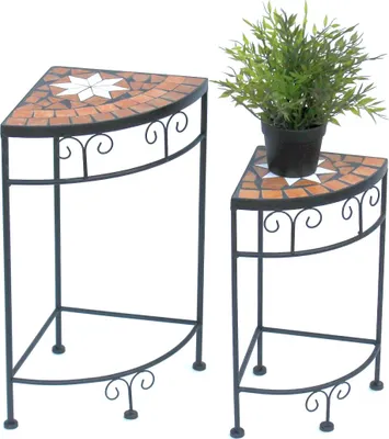 Two corner plant stands with mosaic tops, one with a potted plant.