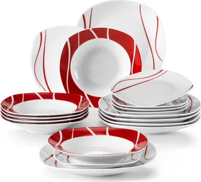 A collection of white ceramic plates and bowls with red curved line designs, arranged in stacks.