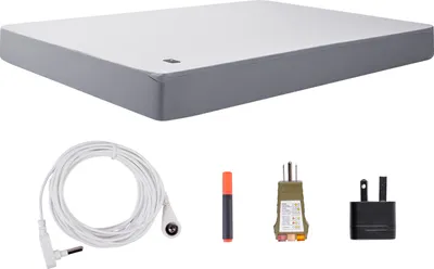A flat lay of a grounding sheet and its accessories, including a power adapter and cables.