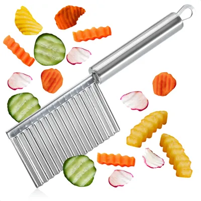 A stainless steel wavy cutter with various cut vegetables and french fries arranged around it on a white background.