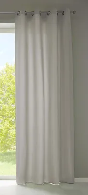 A light gray curtain hanging in front of a window with trees visible outside.