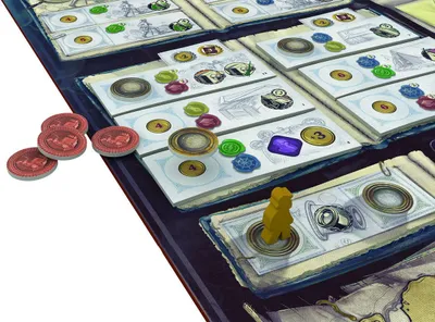 A close-up view of a board game setup, showing game pieces and cards.