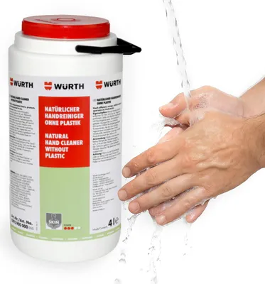 Hands being washed under running water next to a large container of hand cleaner.