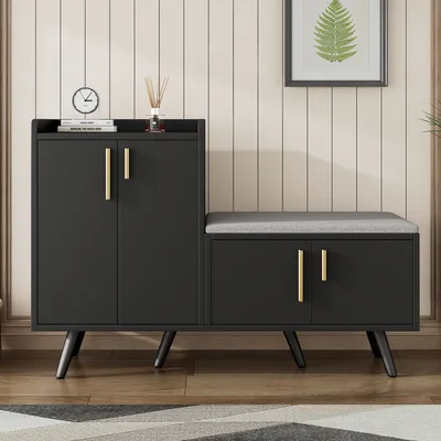 A black shoe cabinet with a gray upholstered bench seat, set against a light-colored paneled wall.