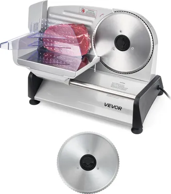 A VEVOR electric meat slicer with a piece of raw meat on the cutting tray, and a separate blade shown below.
