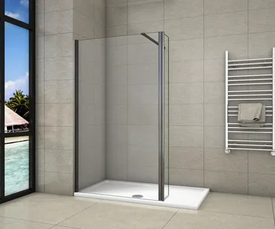 A modern bathroom with a walk-in shower, a towel rack, and a window overlooking a tropical scene.