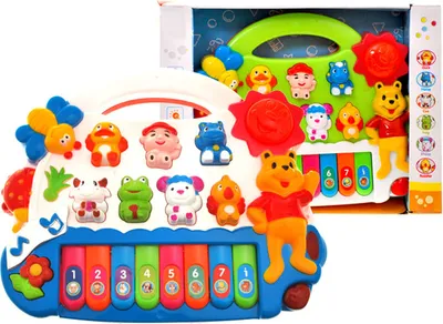 A toy keyboard with animal figures and buttons, presented in its packaging.