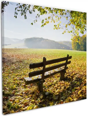 Produktbild von Wallario Premium Leinwandbild Idyllische Holzbank in den Bergen in Größe 50 x 50 cm