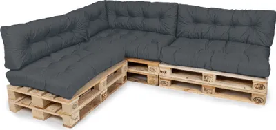 A sectional sofa made of wooden pallets and dark grey cushions.