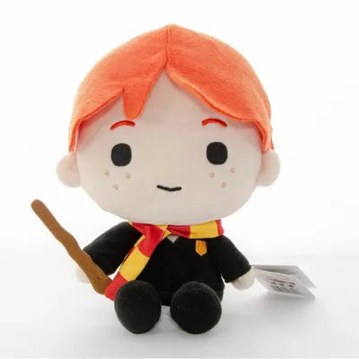 A plush toy of Ron Weasley from Harry Potter, sitting and holding a wand.
