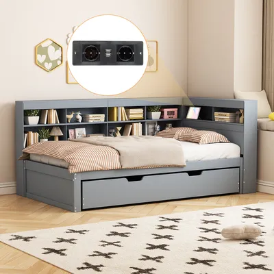 A grey bed with a bookshelf headboard and pull-out drawers, set in a bedroom with a rug and wall art.