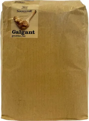 A brown paper bag containing ground galangal.