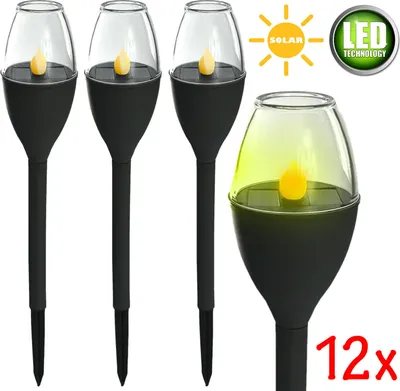 Four solar-powered garden lights shaped like candles, with a larger one in the foreground.