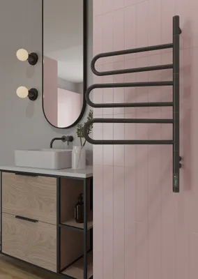 A modern bathroom setting with a vanity, sink, mirror, and a towel warmer.
