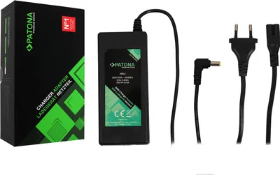 A product shot of a laptop charger and its accessories, along with its packaging.