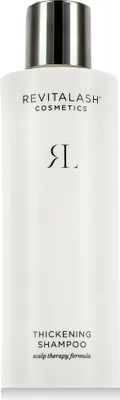 A white bottle of RevitaLash Thickening Shampoo with a silver cap.