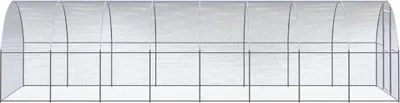 A long, arched greenhouse structure made of galvanized steel and covered with a transparent material.