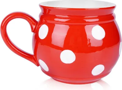 A red and white polka dot ceramic mug.