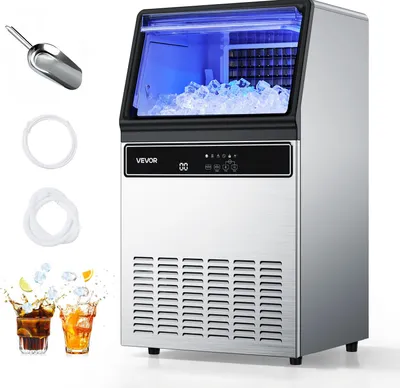 A commercial ice maker with ice cubes inside and accessories.