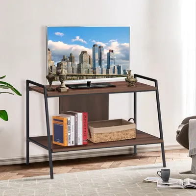 A TV stand with books and a basket on it, with a cityscape painting on the wall behind it.