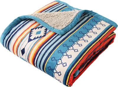 A folded blanket with a Southwestern-inspired pattern.