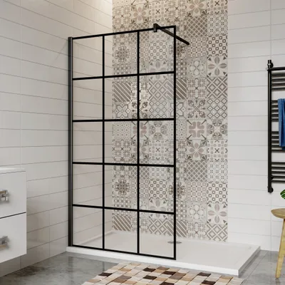 A modern bathroom with a black-framed glass shower wall.