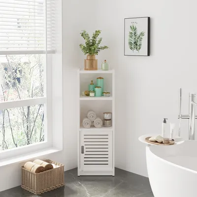 A white bathroom cabinet with shelves and a door, placed in a bathroom corner next to a window and a bathtub.
