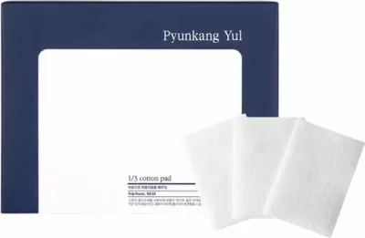 A product shot of Pyunkang Yul 1/3 cotton pads with packaging in the background.