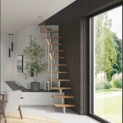 A modern interior with a spiral staircase and large window overlooking a garden.