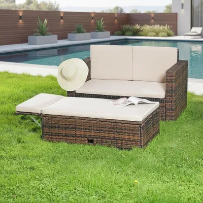 Outdoor lounge set by a swimming pool on a sunny day.