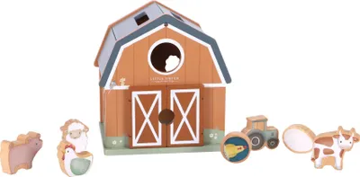 A wooden toy farm set including a barn, tractor, and farm animals, displayed on a white background.