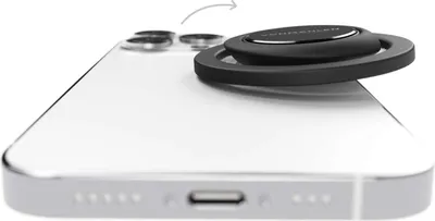 A black magnetic phone holder attached to the back of a white smartphone.