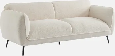 A cream-colored bouclé sofa with black metal legs is shown against a white background.