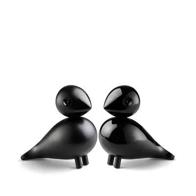 Two black decorative bird figures are shown against a white background.