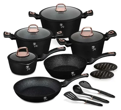A collection of black cookware with rose gold handles and accents, displayed on a white background.