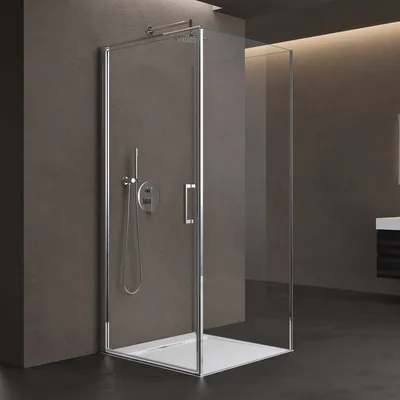 A modern shower cabin with a glass door and chrome fixtures, set against a dark gray wall and black floor.
