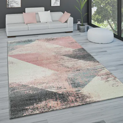 A modern living room with a sofa, rug, and large window.
